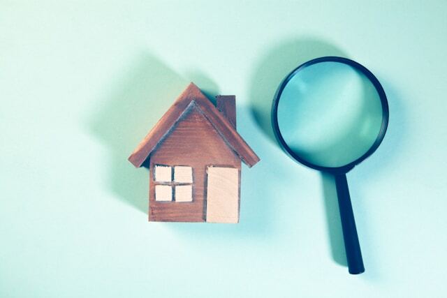 toy house and a magnifying glass